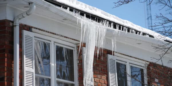 Roof covered in ice, highlighting issues related to ice dam damage.